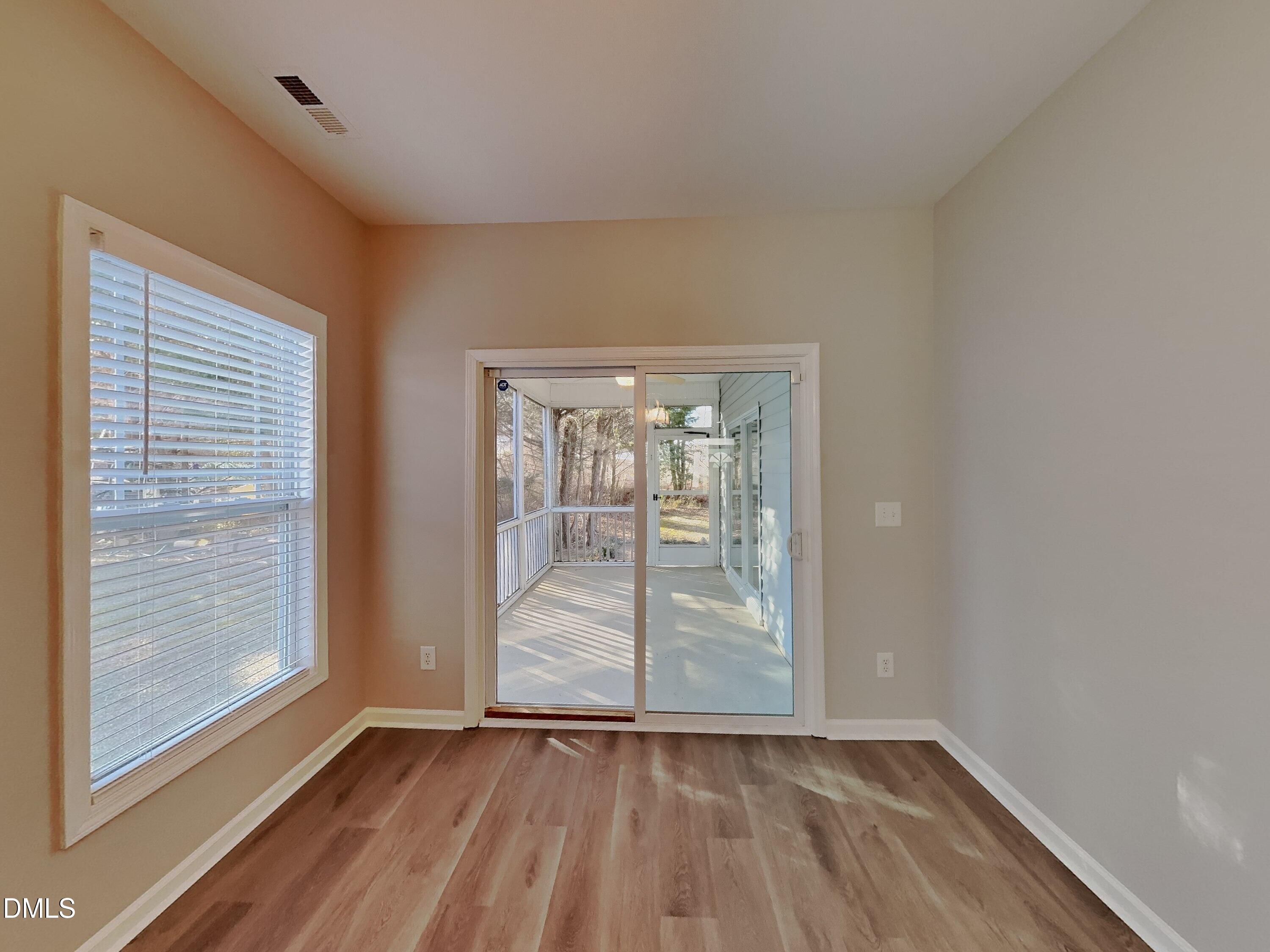 3152 Landing Falls Lane Raleigh, NC 27616 - Photo 4 of 24 an empty room with wooden floor and door