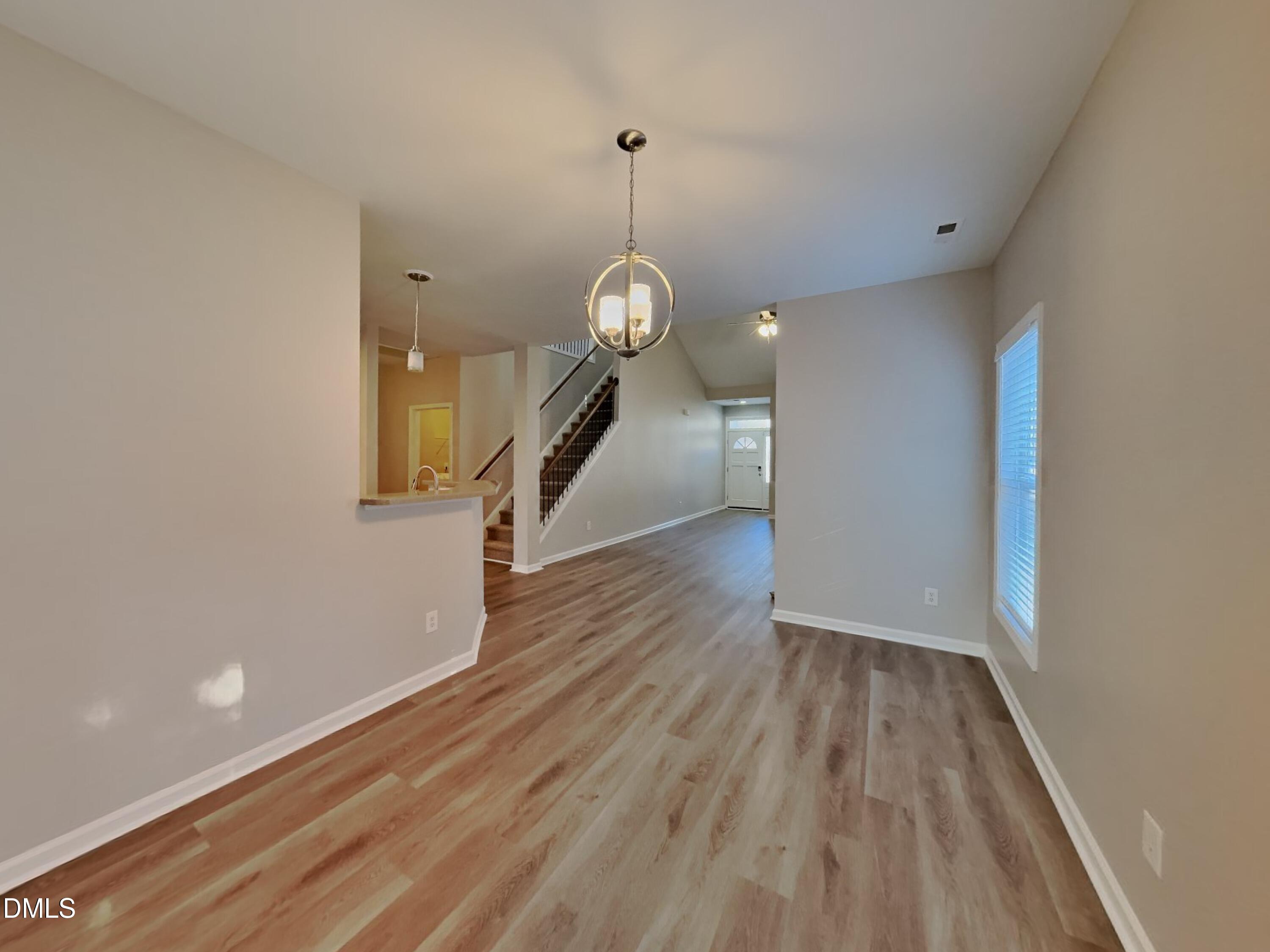 3152 Landing Falls Lane Raleigh, NC 27616 - Photo 5 of 24 a view of a hallway with wooden floor and staircase