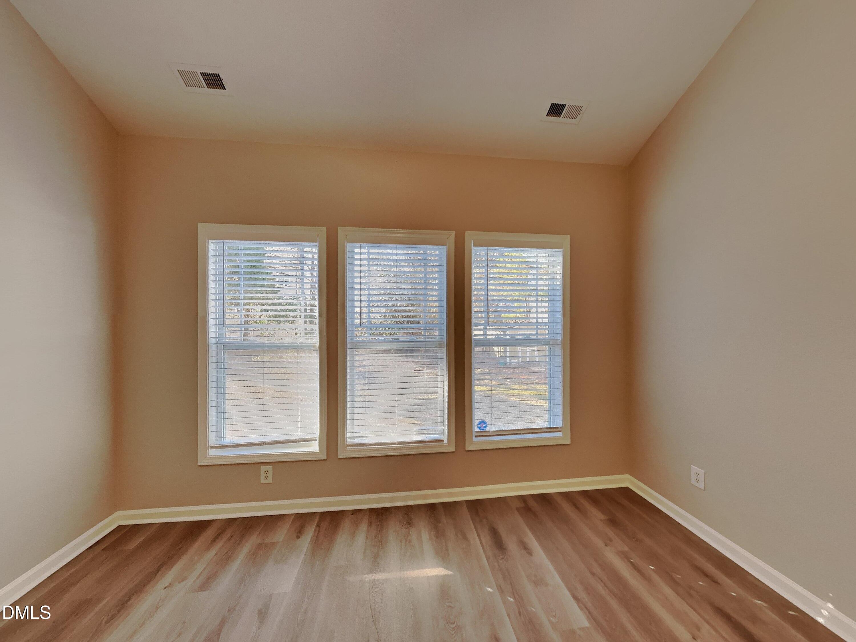 3152 Landing Falls Lane Raleigh, NC 27616 - Photo 9 of 24 an empty room with wooden floor and windows