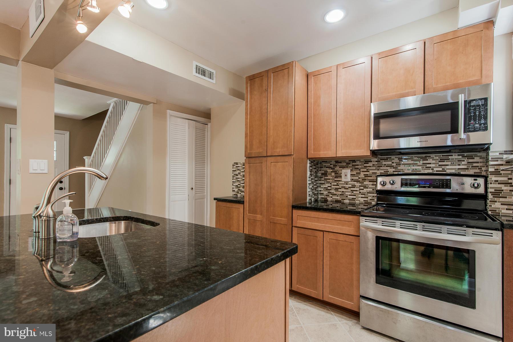 34 Eastship Road Baltimore, MD 21222 - Photo 2 of 19 a kitchen with stainless steel appliances granite countertop a sink a stove microwave and refrigerator