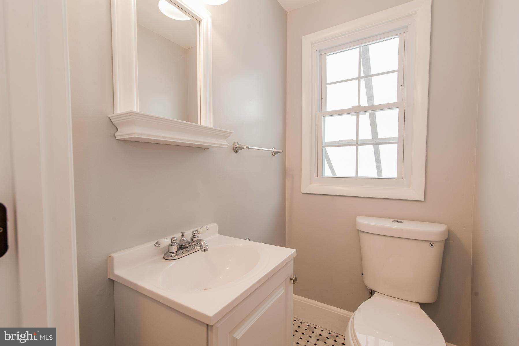 34 Eastship Road Baltimore, MD 21222 - Photo 14 of 19 a bathroom with a toilet sink and mirror