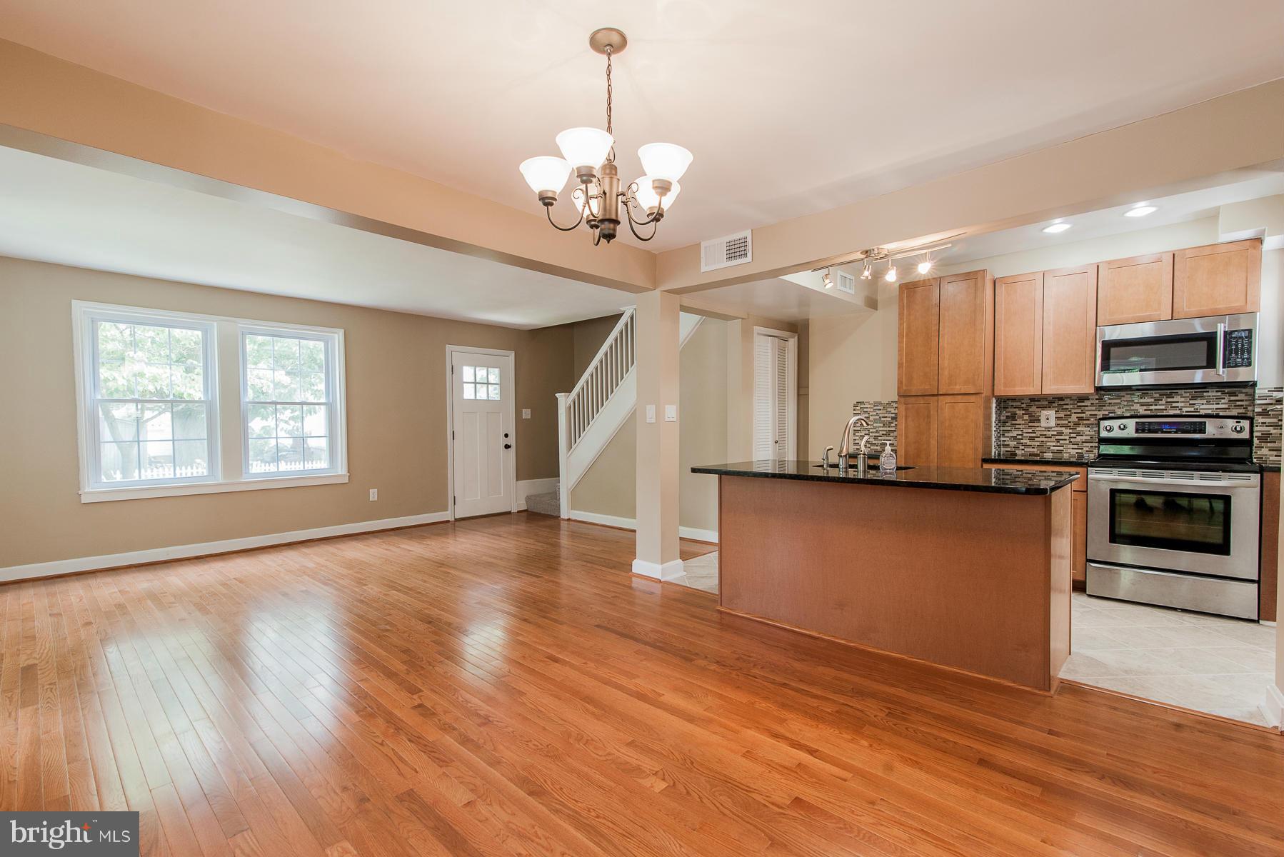 34 Eastship Road Baltimore, MD 21222 - Photo 3 of 19 a view of a kitchen with a stove wooden cabinet and a refrigerator