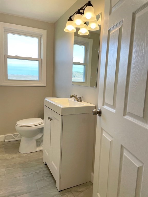 57 Marshview Drive Marshfield, MA 02050 - Photo 5 of 13 a bathroom with a toilet sink and mirror