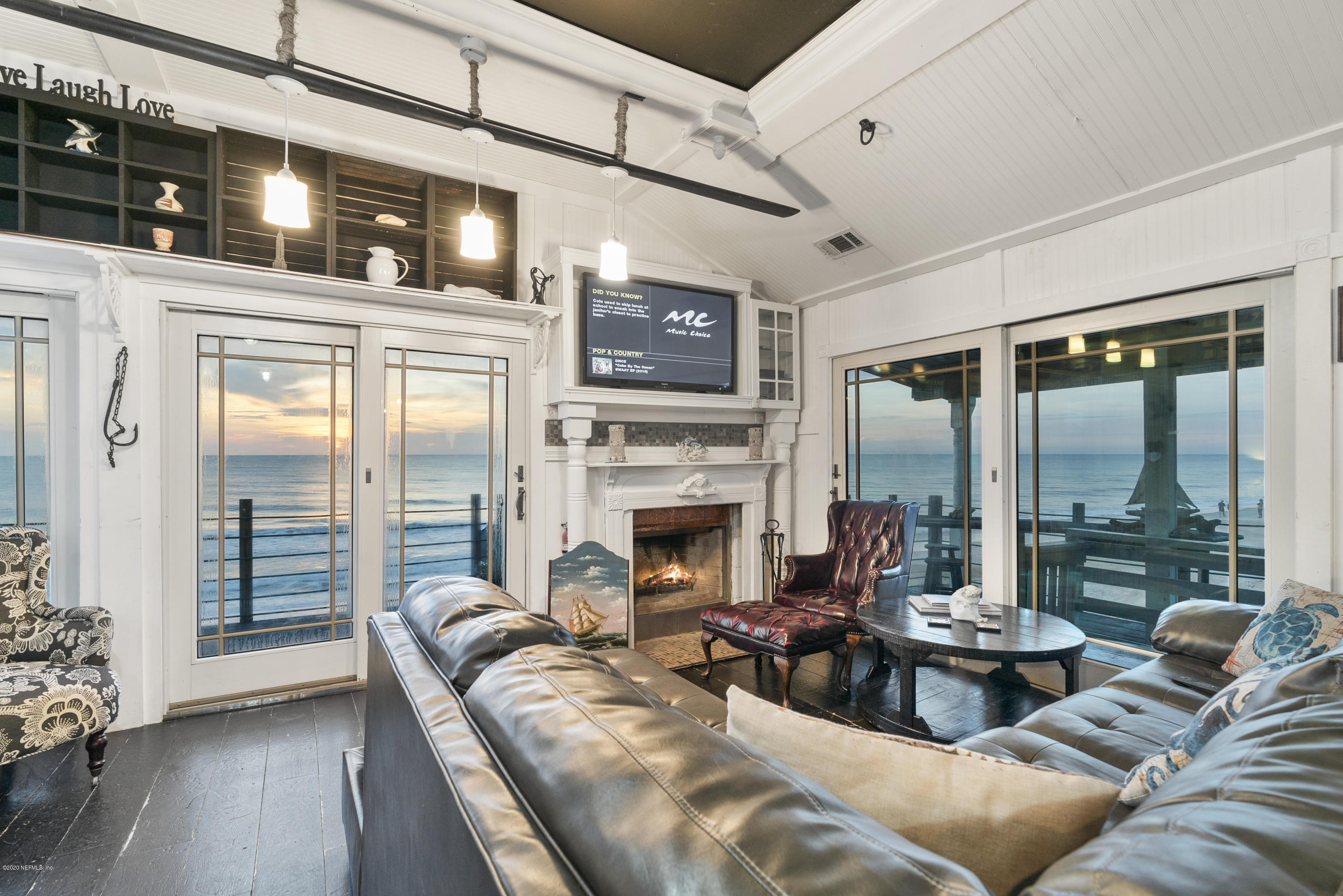 3490 Coastal Highway St. Augustine, FL 32084 - Photo 30 of 72 a living room with furniture a fireplace and a flat screen tv