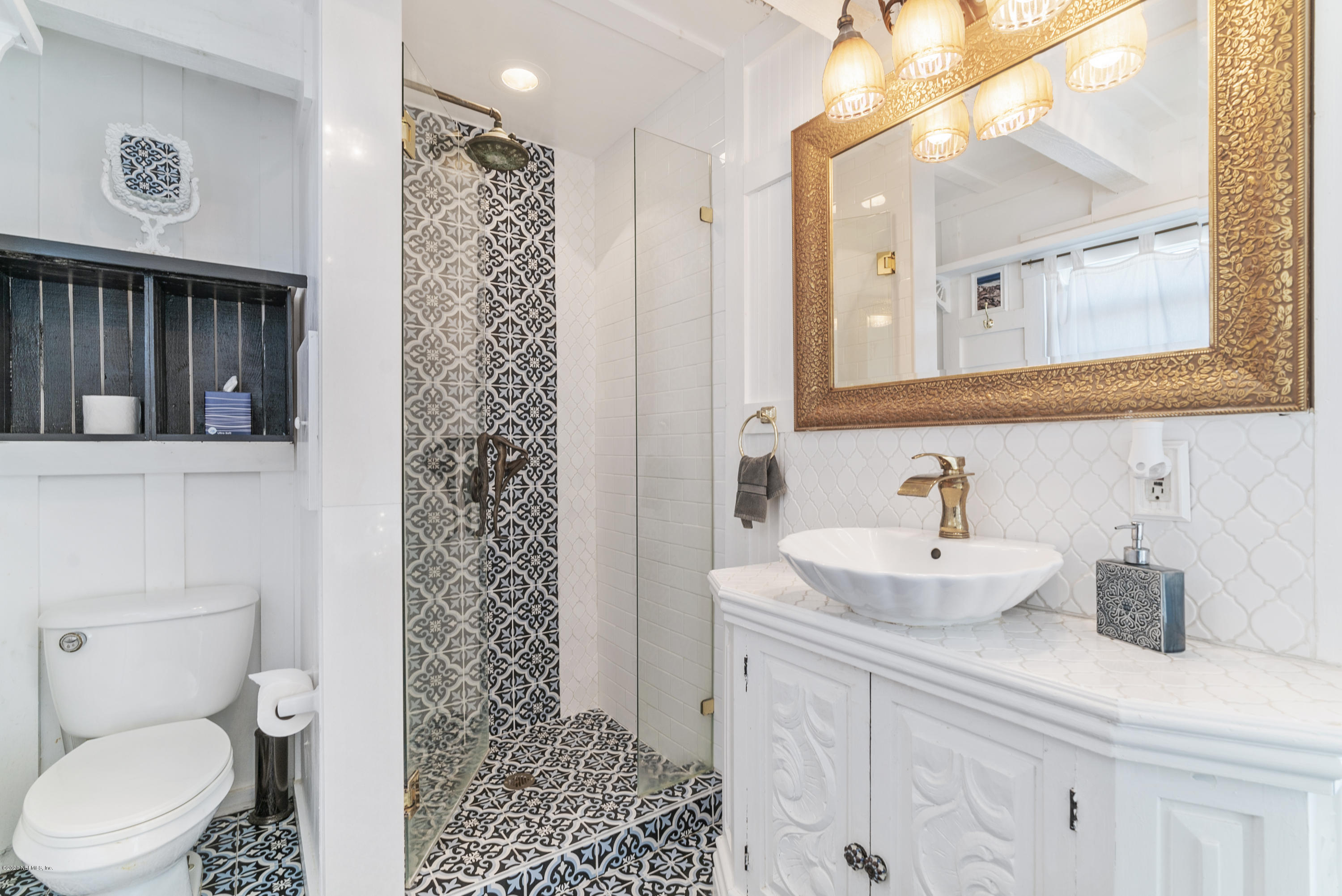 3490 Coastal Highway St. Augustine, FL 32084 - Photo 43 of 72 a bathroom with a sink a toilet and shower