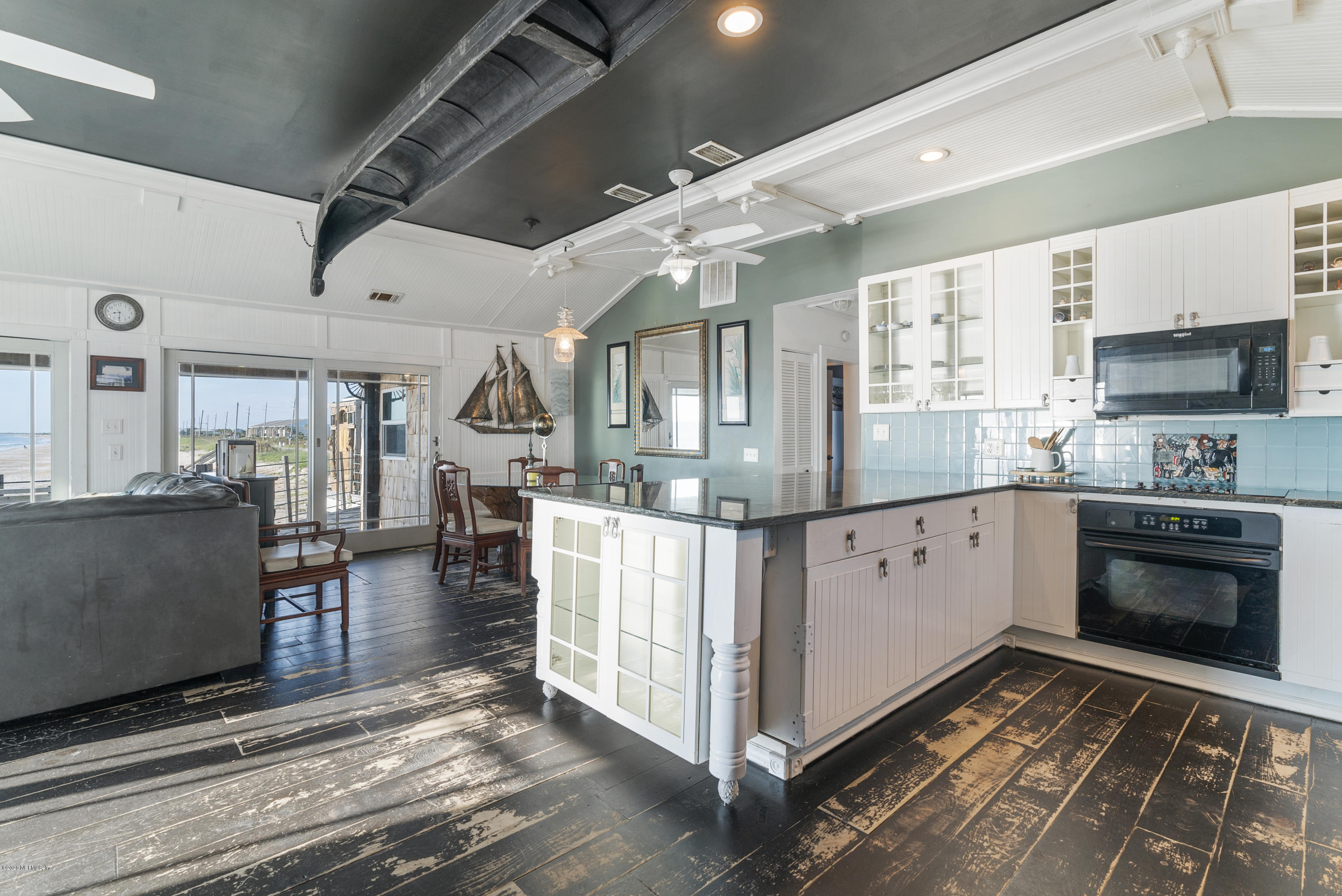 3490 Coastal Highway St. Augustine, FL 32084 - Photo 52 of 72 a kitchen with stainless steel appliances granite countertop a stove and cabinets
