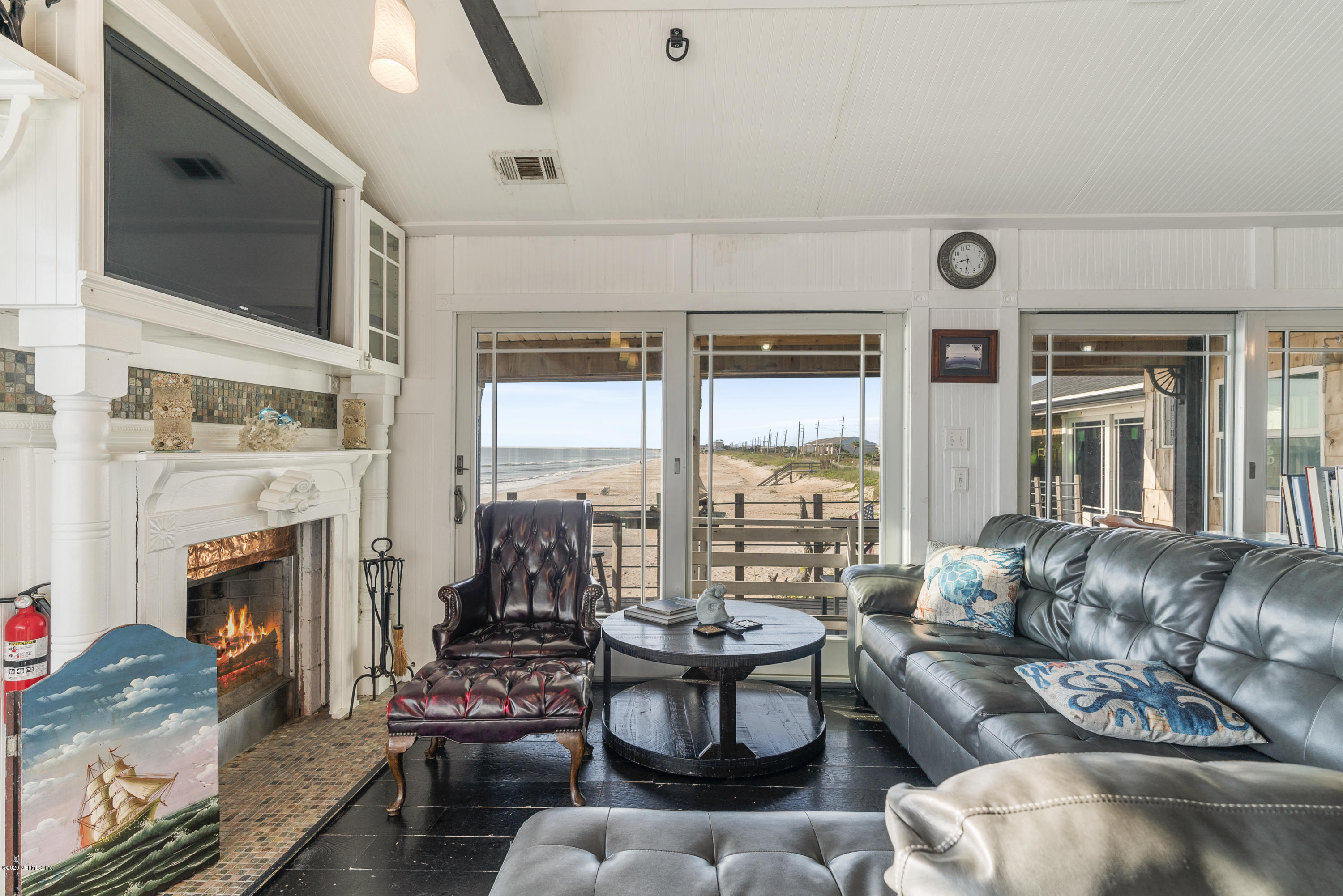 3490 Coastal Highway St. Augustine, FL 32084 - Photo 56 of 72 a living room with furniture large window and fireplace
