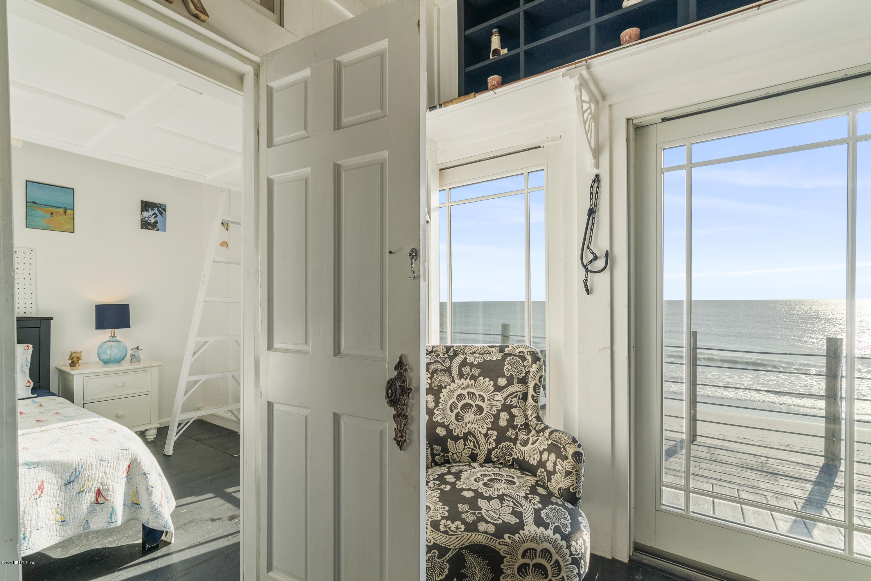 3490 Coastal Highway St. Augustine, FL 32084 - Photo 58 of 72 a bedroom with a bed and a chair
