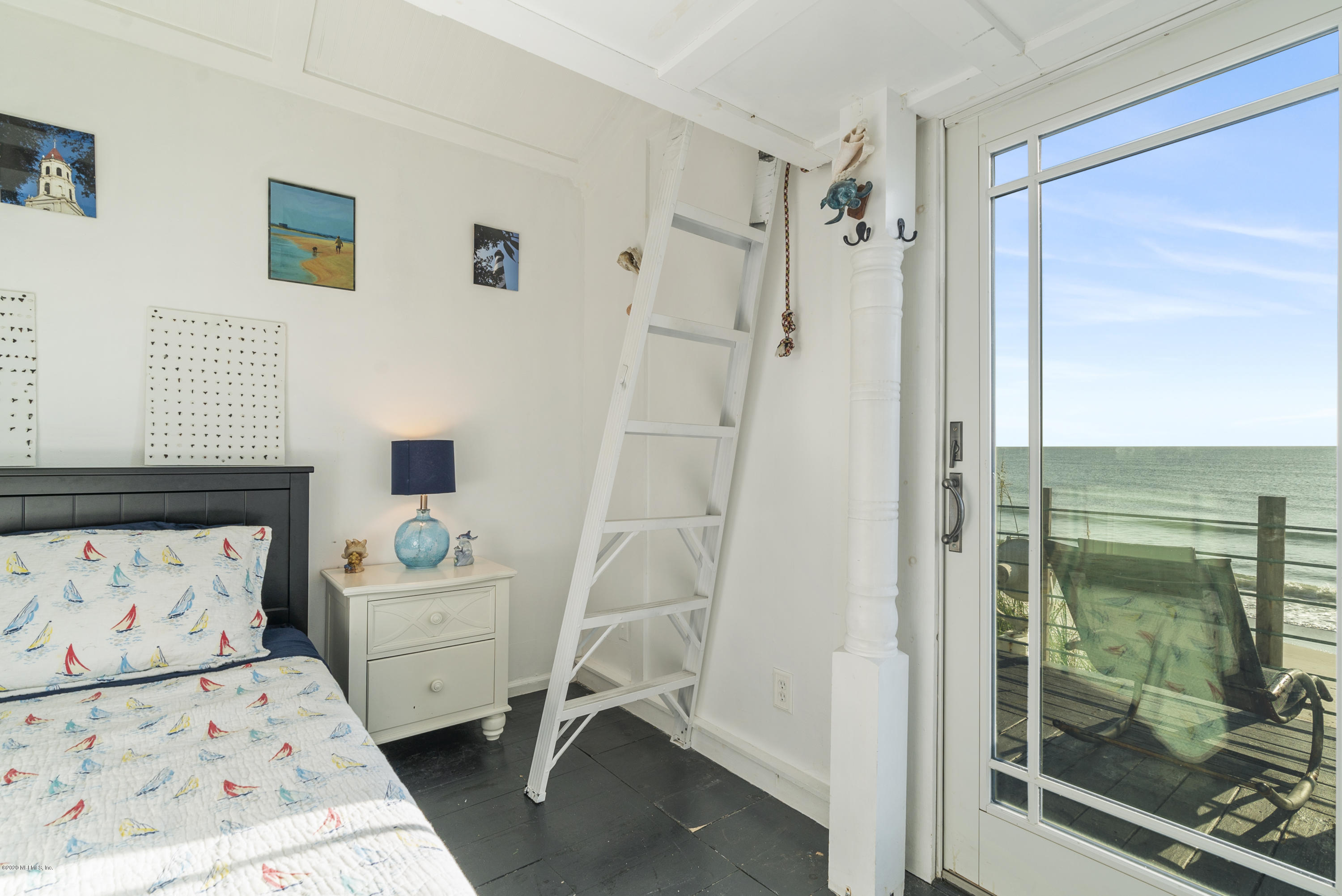 3490 Coastal Highway St. Augustine, FL 32084 - Photo 60 of 72 a view of a bedroom with baby bed and a window