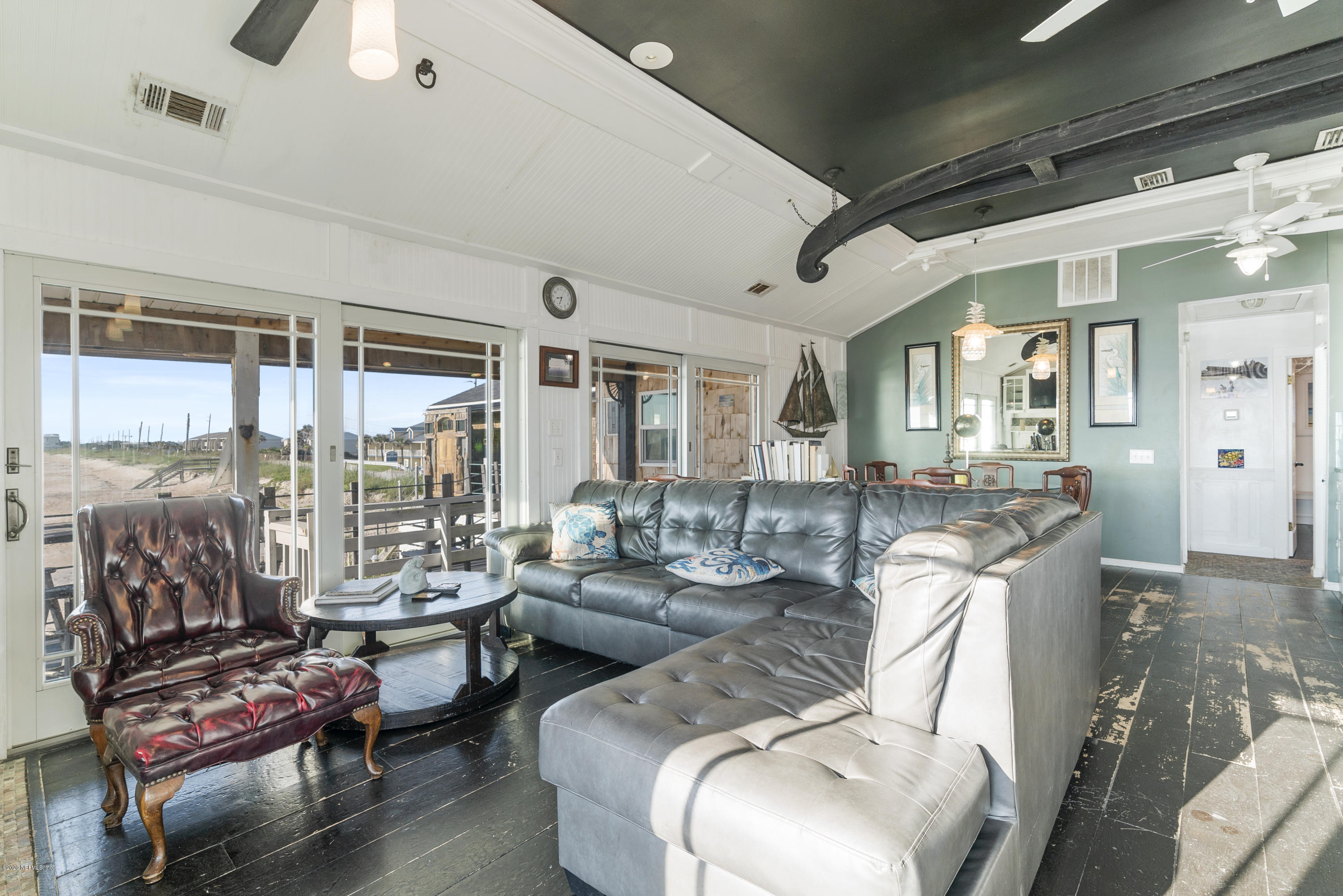 3490 Coastal Highway St. Augustine, FL 32084 - Photo 61 of 72 a living room with furniture and a floor to ceiling window