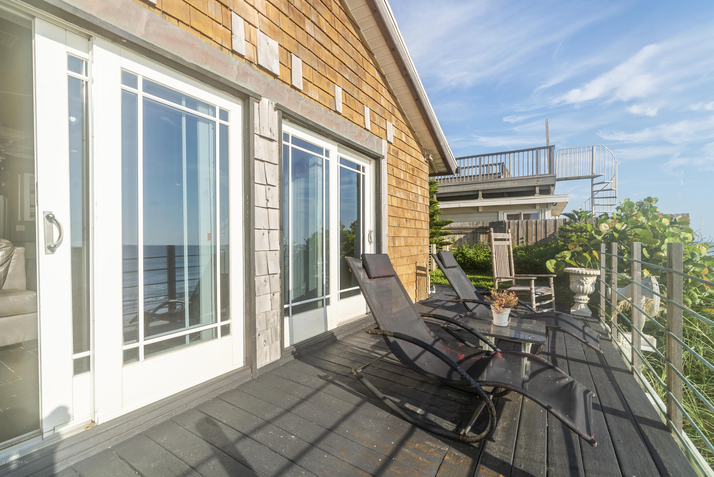 3490 Coastal Highway St. Augustine, FL 32084 - Photo 63 of 72 a view of a patio with table and chairs and wooden floor