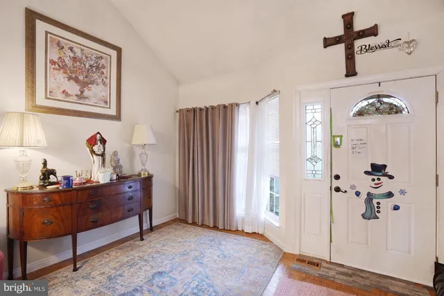 a bedroom with a bed and a flat tv screen on the dresser