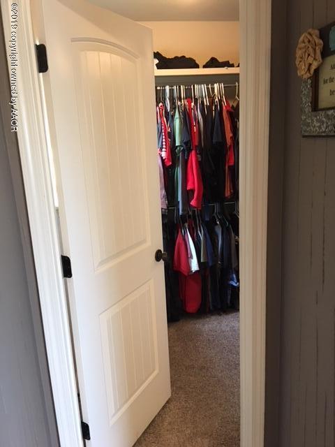 7303 Rochester Drive Amarillo, TX 79118 - Photo 14 of 20 a view of walk in closet with clothes