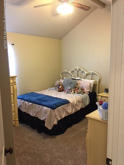 7303 Rochester Drive Amarillo, TX 79118 - Photo 18 of 20 a bed sitting in a bedroom next to a window