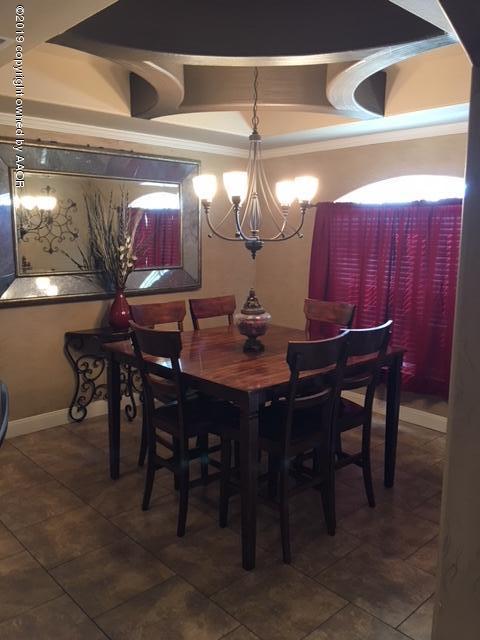 7303 Rochester Drive Amarillo, TX 79118 - Photo 5 of 20 a view of a dining room with furniture and chandelier