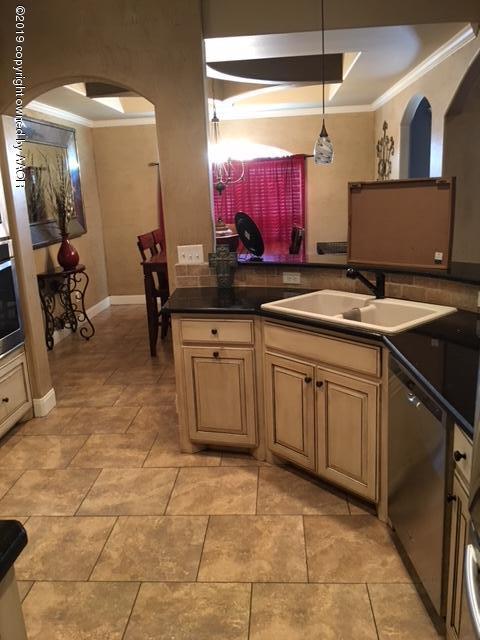 7303 Rochester Drive Amarillo, TX 79118 - Photo 7 of 20 a kitchen with a sink and cabinets