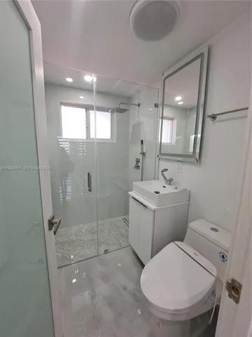 a bathroom with a sink toilet and shower