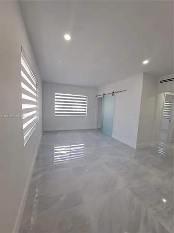 a view of empty room with a fireplace