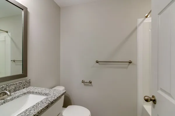 a white toilet sitting next to a bathroom sink