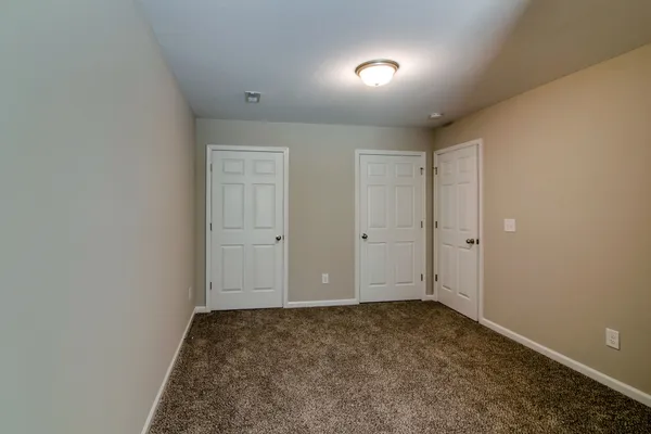 a living room with furniture a flat screen tv and a window