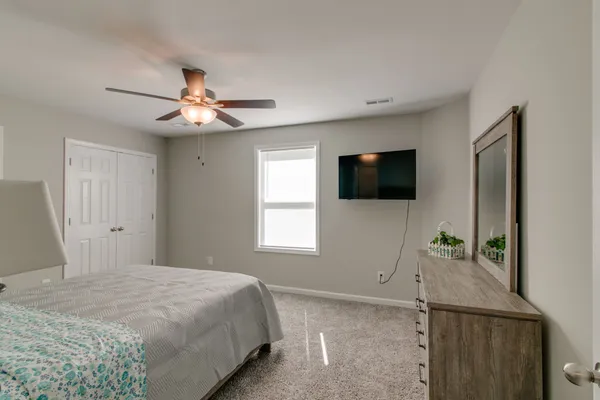 a bedroom with a bed and a window