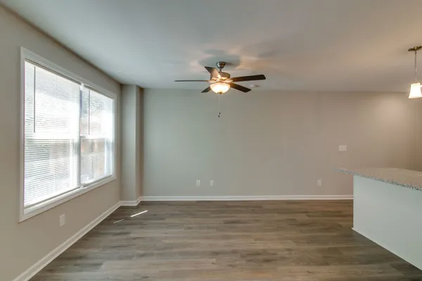 a view of kitchen with kitchen island microwave and stove