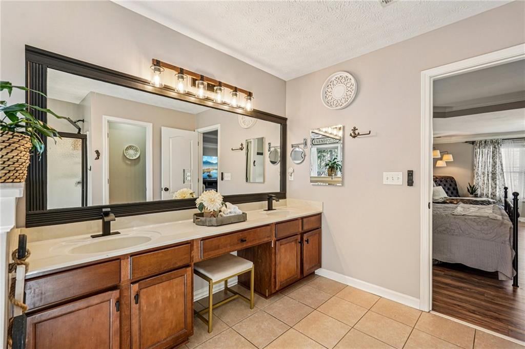 909 Elderberry Lane Villa Rica, GA 30180 - Photo 17 of 34 a spacious bathroom with a double vanity sink and a mirror