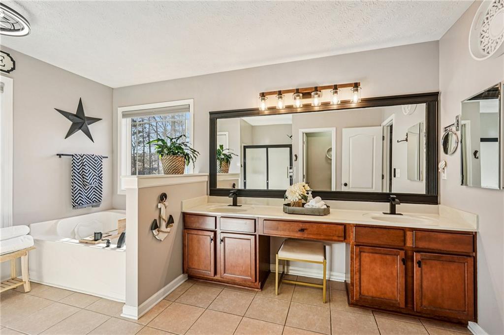 909 Elderberry Lane Villa Rica, GA 30180 - Photo 18 of 34 a bathroom with a sink double vanity and a mirror
