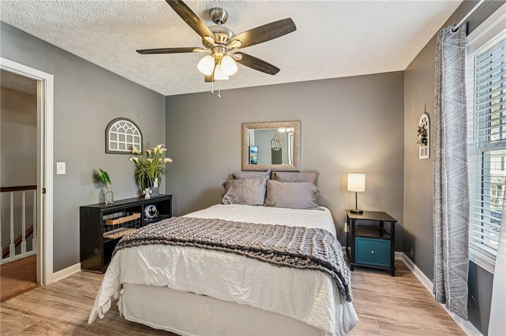 909 Elderberry Lane Villa Rica, GA 30180 - Photo 21 of 34 a bedroom with a bed and a chandelier