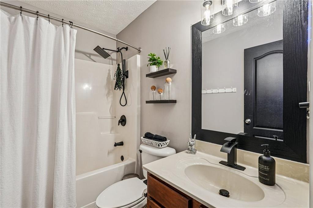 909 Elderberry Lane Villa Rica, GA 30180 - Photo 22 of 34 a bathroom with a sink toilet tub and shower
