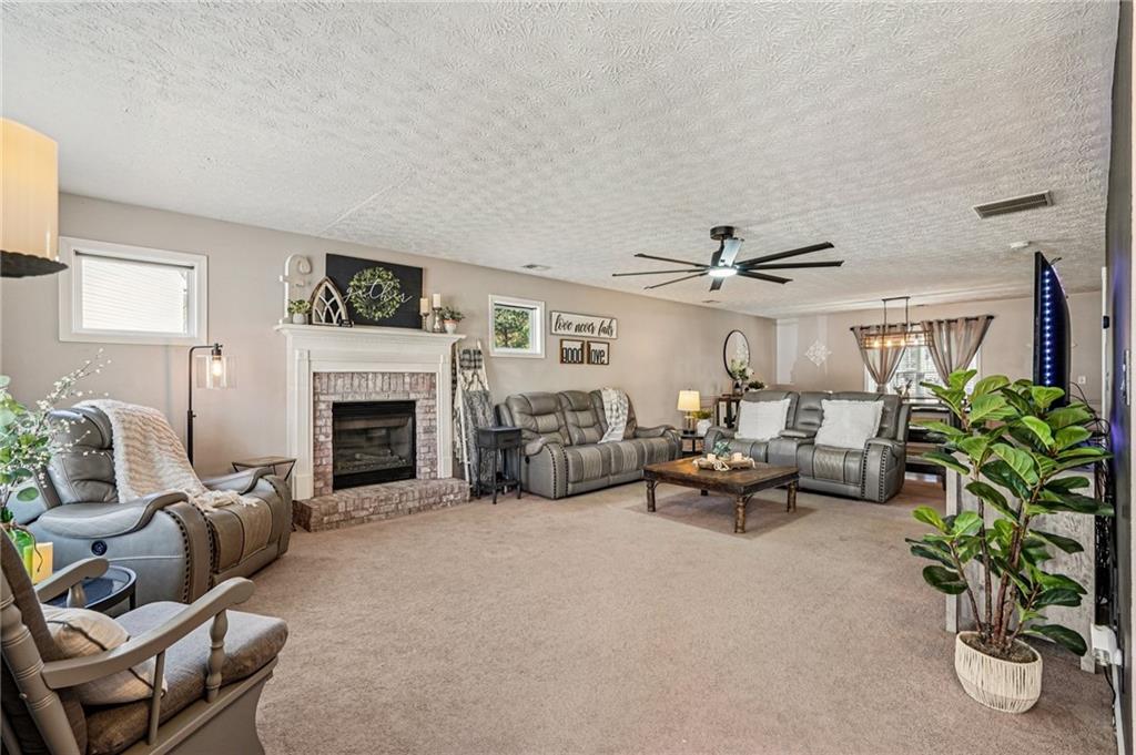 909 Elderberry Lane Villa Rica, GA 30180 - Photo 3 of 34 a living room with furniture a fireplace and a potted plant