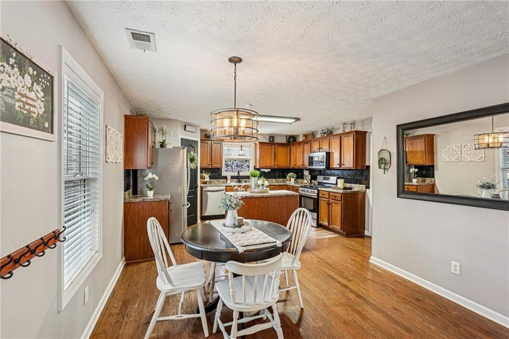 909 Elderberry Lane Villa Rica, GA 30180 - Photo 8 of 34 a dining room with furniture and kitchen view