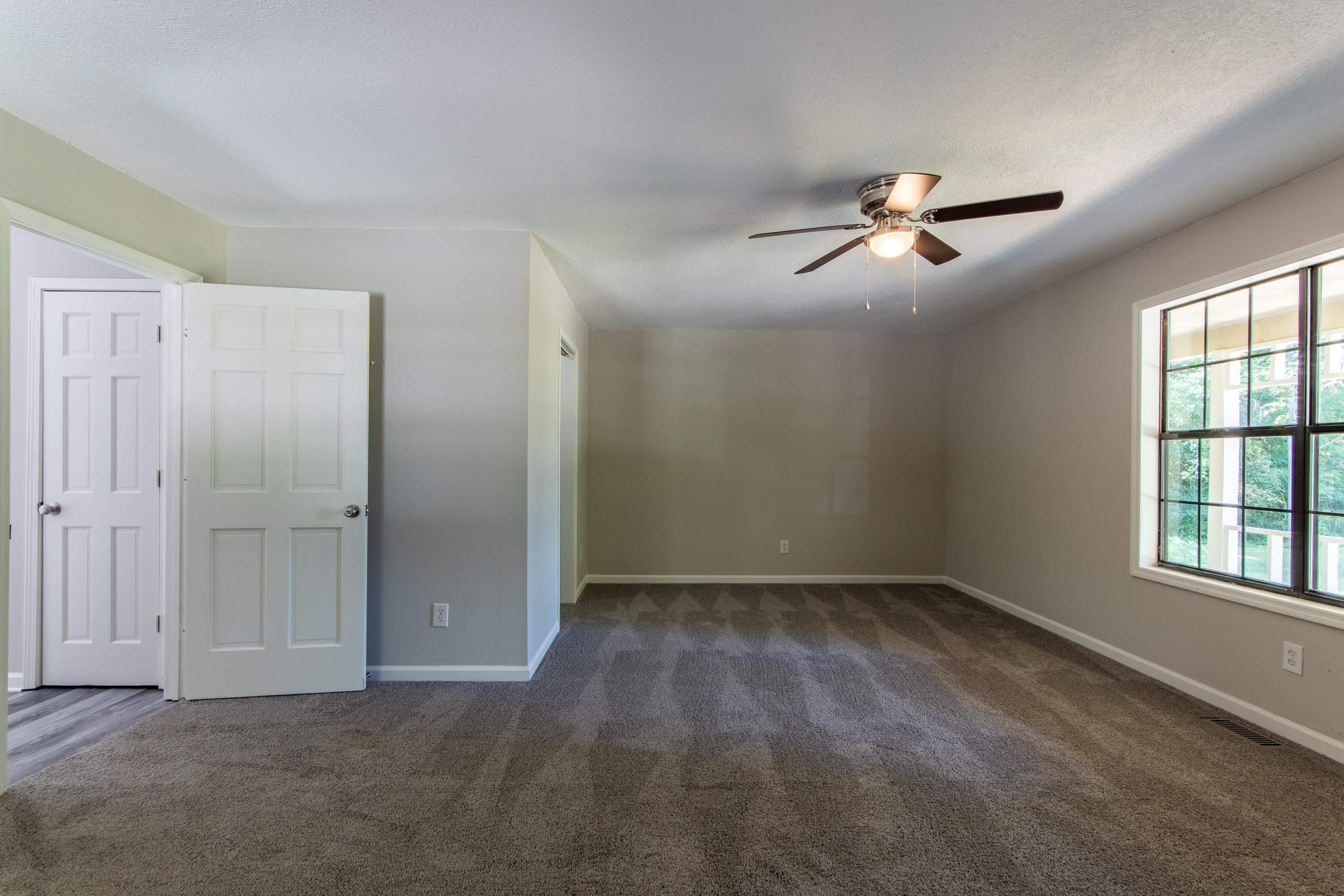 1020 County Road 600 Corinth, MS 38834 - Photo 13 of 37 an empty room with windows and fan
