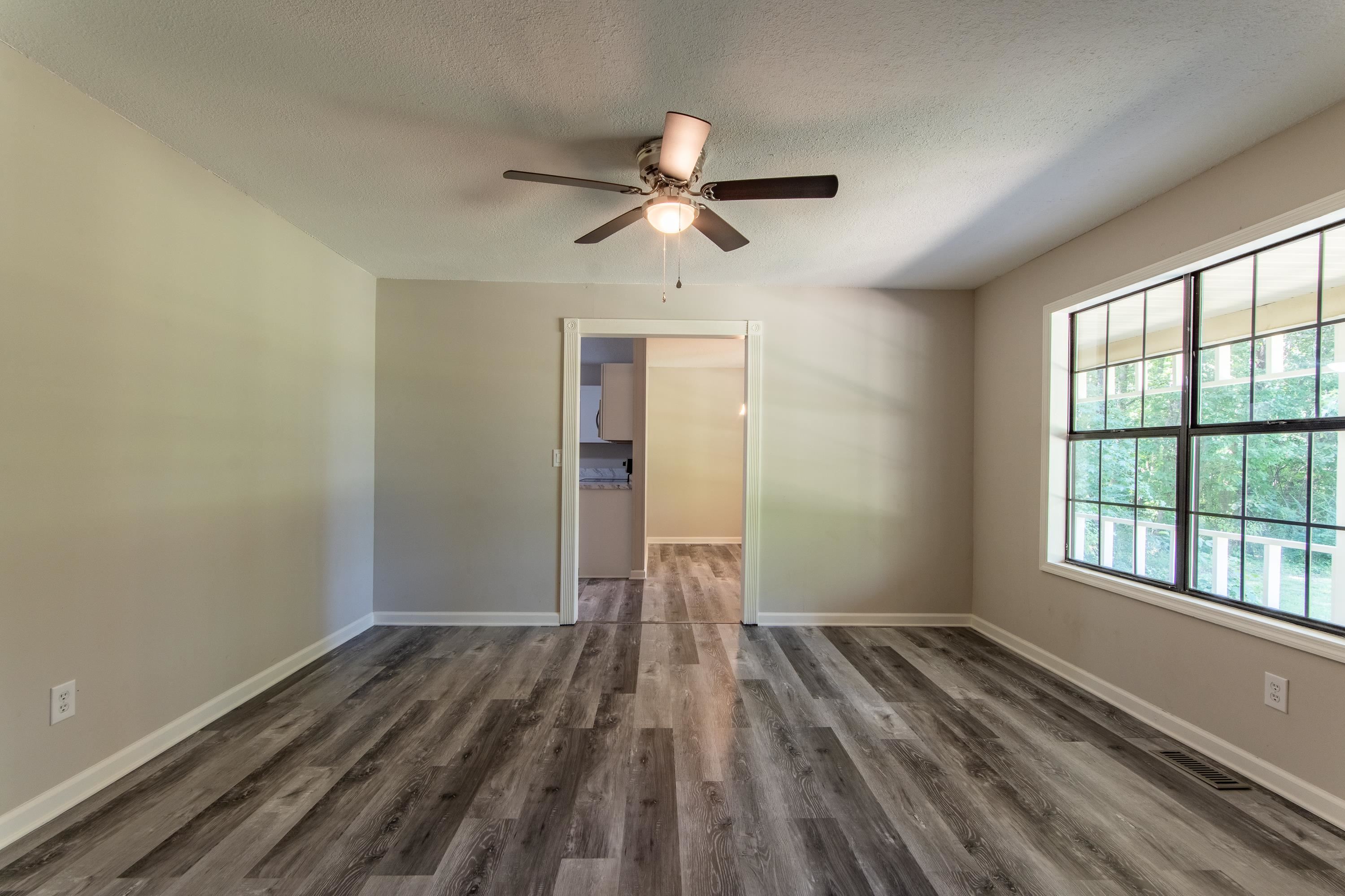 1020 County Road 600 Corinth, MS 38834 - Photo 16 of 37 a view of empty room with wooden floor and fan