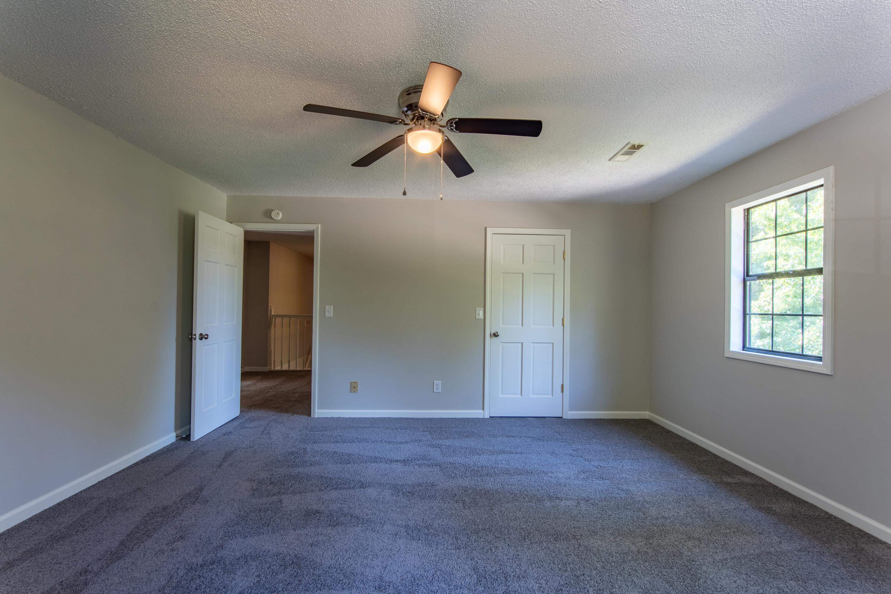 1020 County Road 600 Corinth, MS 38834 - Photo 26 of 37 an empty room with windows and a ceiling fan