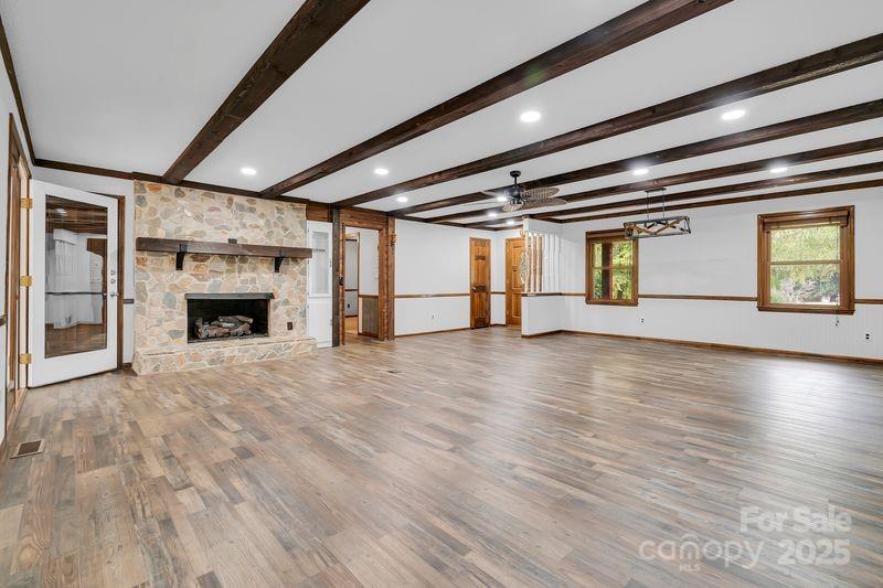 268 State Rd S-42-4322 Chesnee, SC 29323 - Photo 6 of 44 an empty room with wooden floor and fireplace