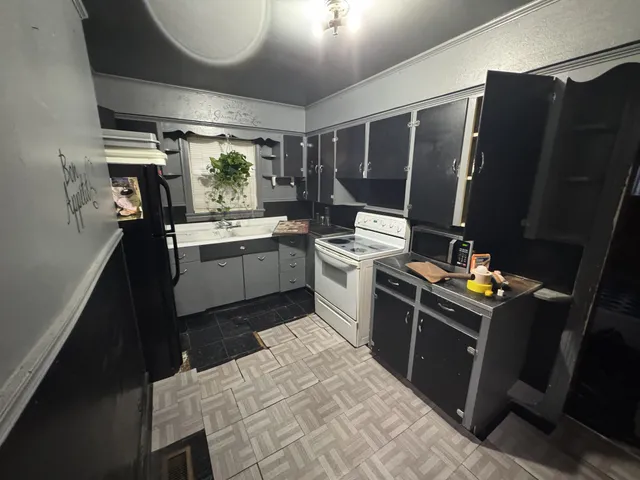 a kitchen with sink refrigerator and stove