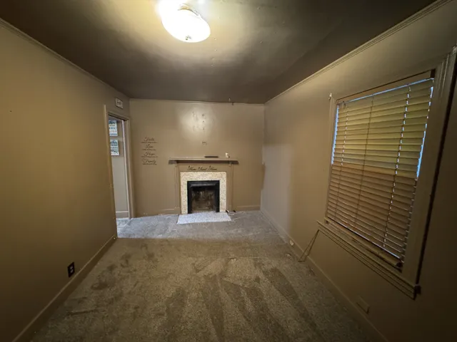 a view of an empty room with a fireplace