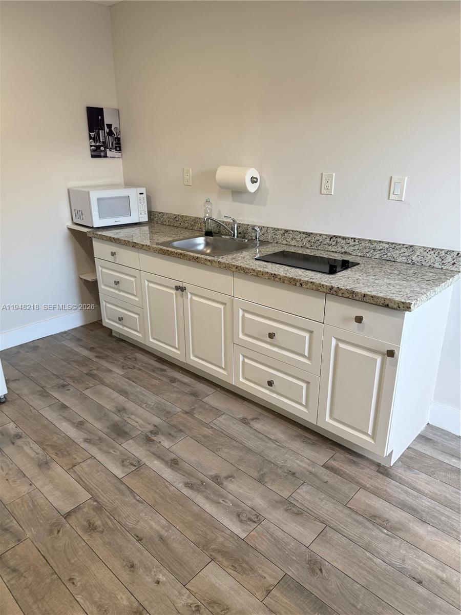 15740 Southwest 102nd Place Miami, FL 33157 - Photo 5 of 10 a spacious bathroom with a granite countertop sink and a mirror