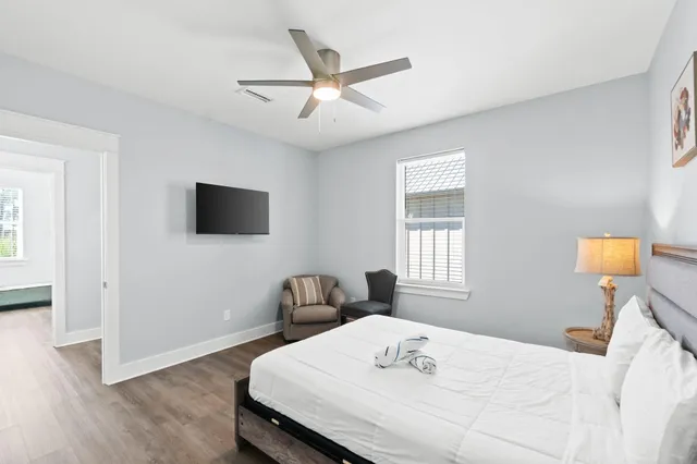 a bedroom with a bed and a flat screen tv