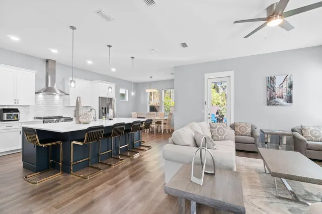 a large kitchen with a table and chairs