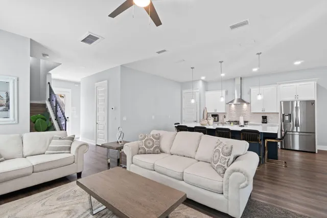 a view of a living room kitchen and a wooden floor