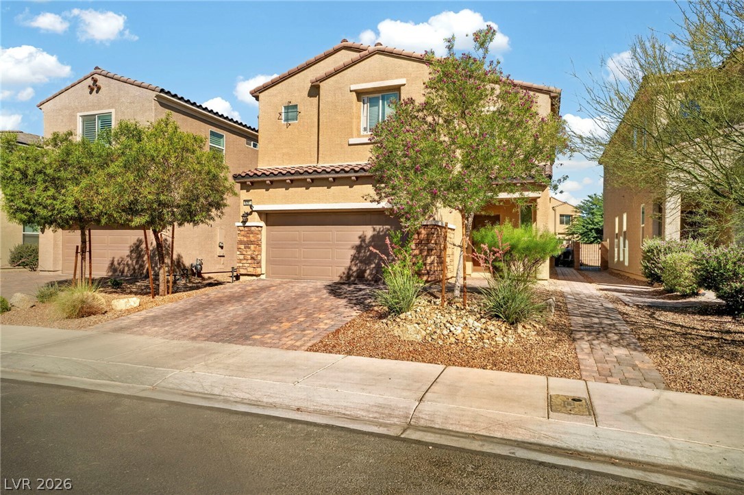 6281 Angora Peak Lane Las Vegas, NV 89115 - Photo 3 of 34 A welcoming residence featuring a paver driveway, attractive xeriscaping, and a charming front facade.