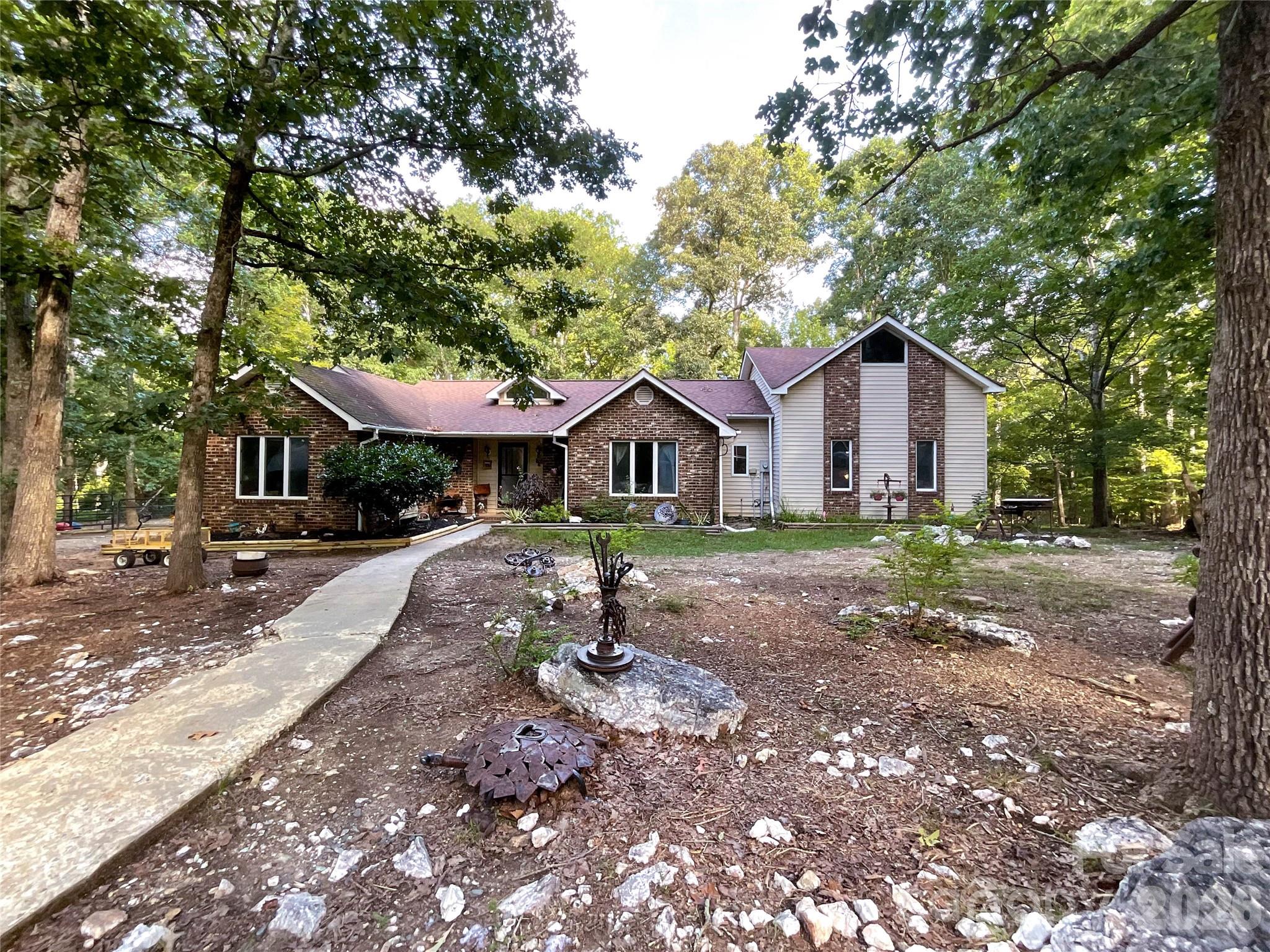 7200 Nesbit Road Waxhaw, NC 28173 - Photo 3 of 47 a front view of a house with a yard and trees