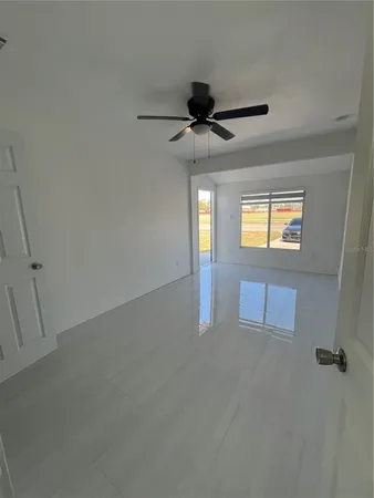 en empty room with windows and ceiling fan view