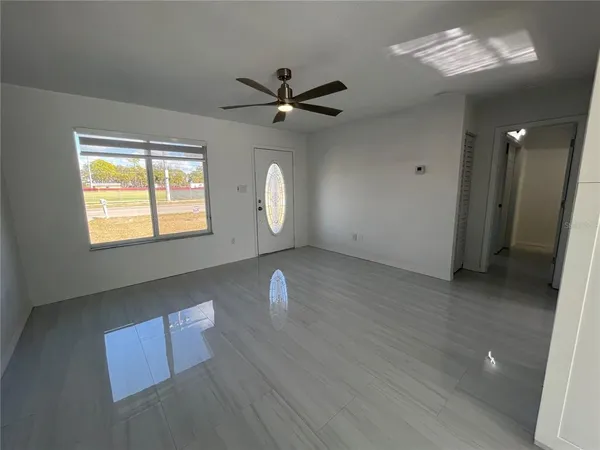 wooden floor in an empty room with a window
