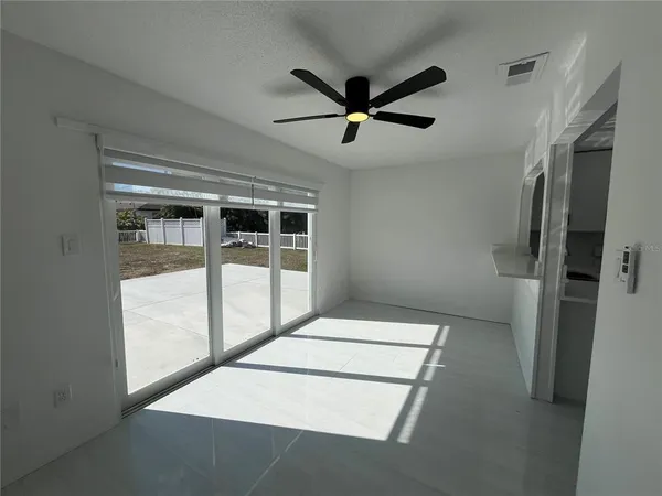 a hallway with sliding door and ceiling fan