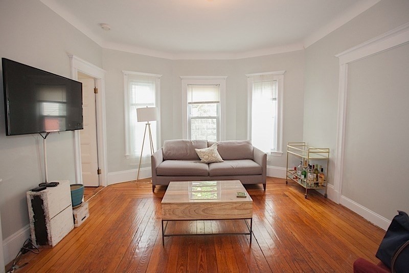 50 Holyoke Road, Unit 1 Somerville, MA 02144 - Photo 5 of 14 a living room with furniture and a flat screen tv