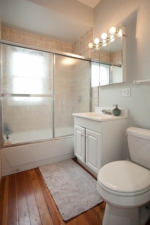 50 Holyoke Road, Unit 1 Somerville, MA 02144 - Photo 7 of 14 a bathroom with a sink a toilet a mirror and shower