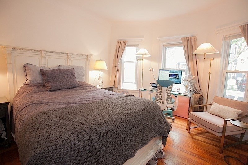 50 Holyoke Road, Unit 1 Somerville, MA 02144 - Photo 9 of 14 a bedroom with a large bed and a large window